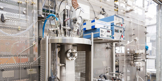 A metal device in a laboratory with various other devices.