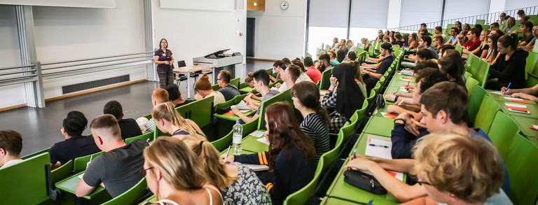 Students sit in a lecture at the beginning of the study.
